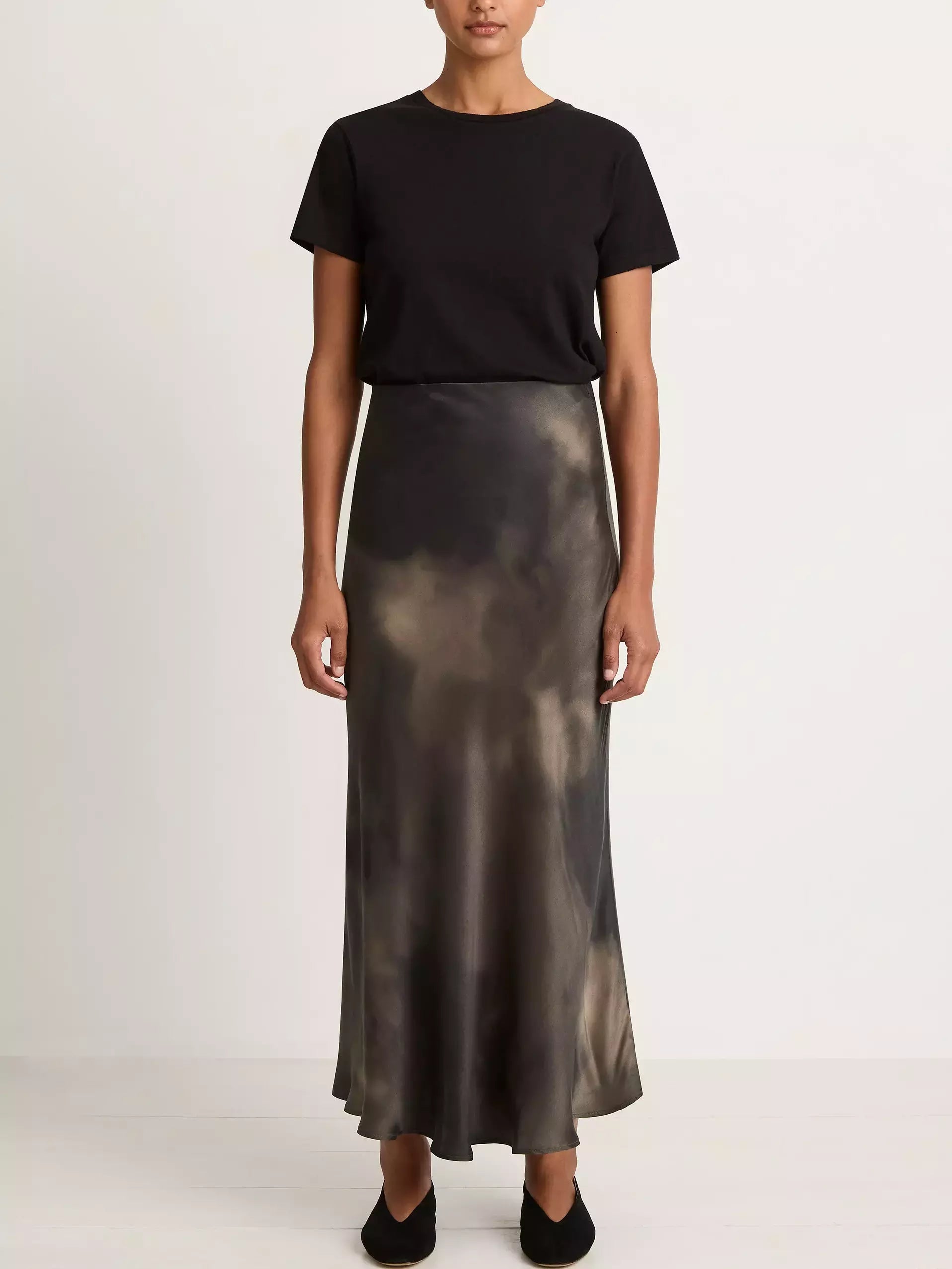 Woman in a black t-shirt with a Silk Sand-Washed Long Skirt in a tie-dye design