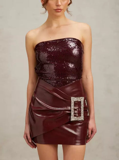 Burgundy strapless sequin mini dress with buckled wrap effect and faux leather skirt