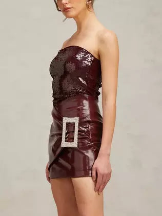 Burgundy strapless sequin mini dress with buckled wrap effect and faux leather skirt